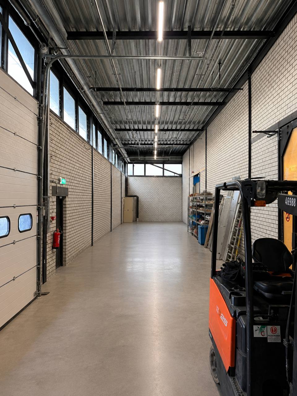 Heftruck bij de laadzone met vrije vloer en overheaddeur in de Cargo Donkey loods in Hoofddorp.